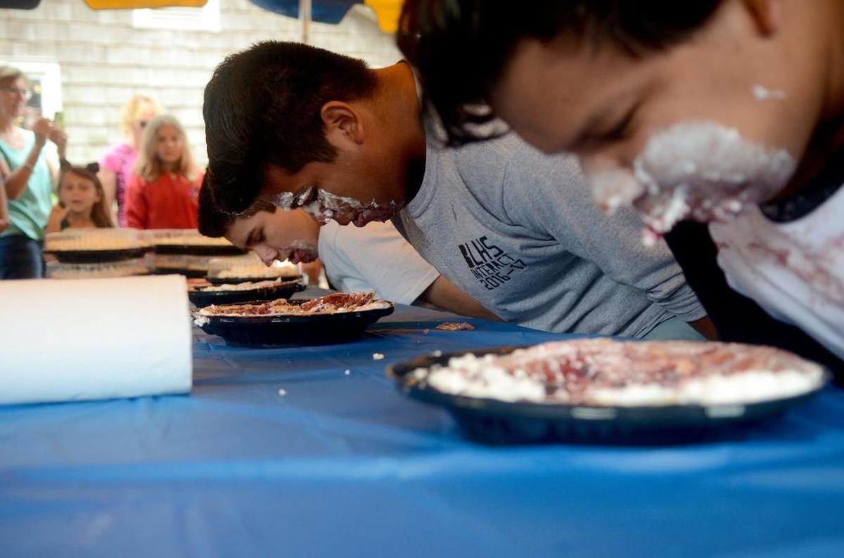 Participants in the 5th annual Pie Eating Contest pause while eating their pies during the 39th annual Bluffton Village Festival on Saturday, May 13, 2017, on Calhoun Street in Bluffton. Aldo Cazales, center, 14, of Bluffton, finished first.