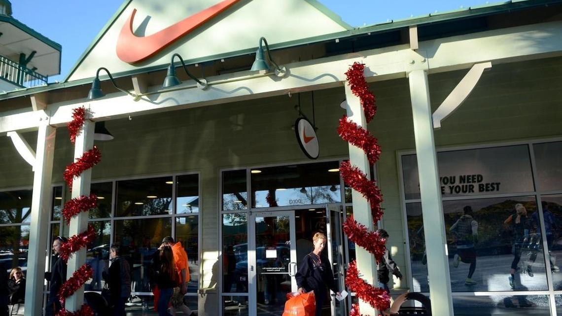 Shoppers leave the Nike Factory Store on Saturday, Dec. 10 , at Tanger Outlets 2 in Bluffton.