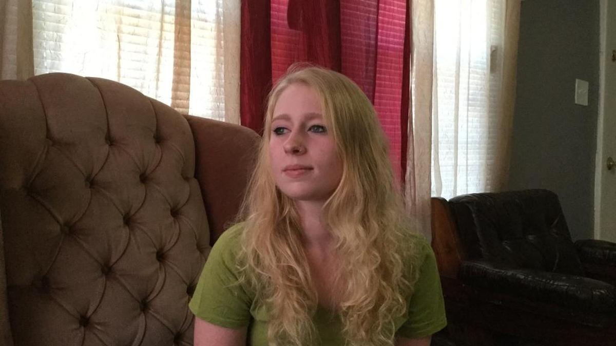 Daryan Payne sits in the living room of the home where she hopes to build a new life.