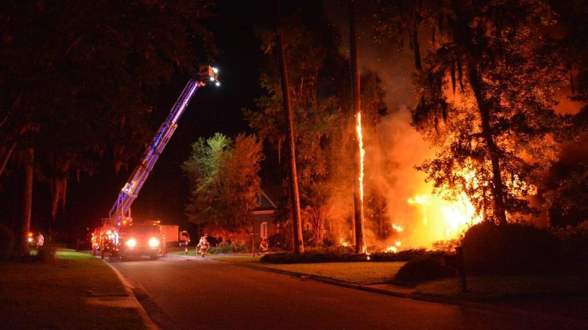 Bluffton firefighters work to extinquish a blaze at 75 Lexington Drive in Belfair Plantation in the early morning hours Saturday.