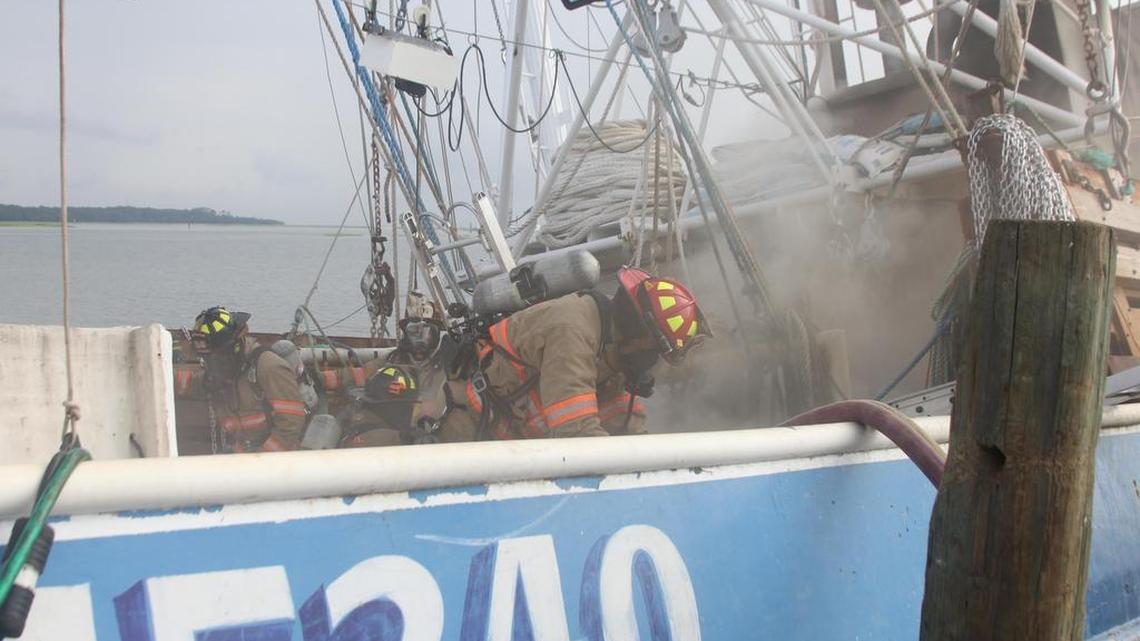 A Hilton Head Island Fire and Rescue firefighter works the scene of a Tuesday boat fire docked at Hudson’s Seafood on Hilton Head Island.