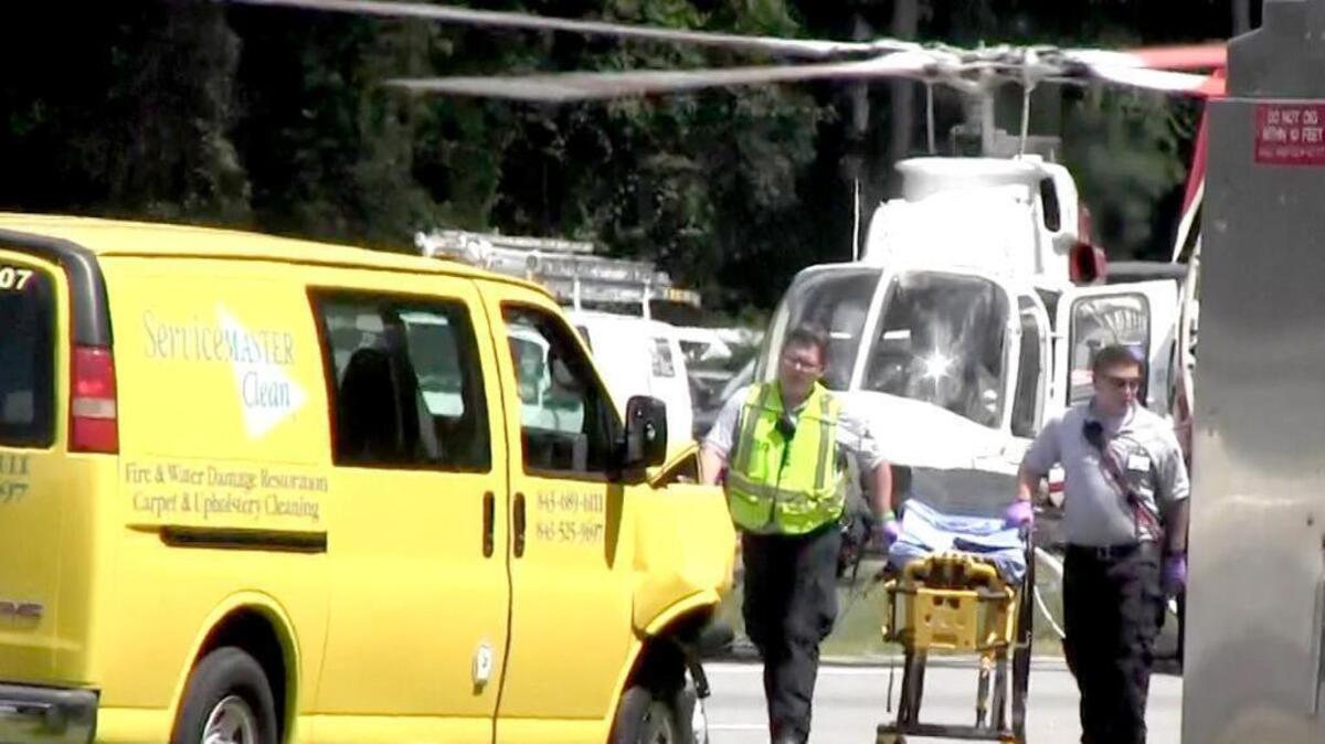 In this still from a video, a damaged van can be seen at the scene of a Tuesday wreck at U.S. 278 and Buck Island Road in Bluffton as emergency personnel report back to their ambulance after loading a patient into a helicopter for transport.