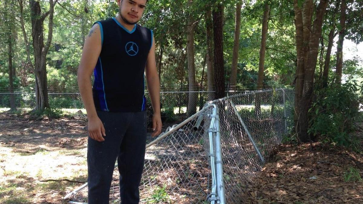 Manny Patlan stands beside the mangled chain-link fence on his property at 71 Shults Rd. in Bluffton on Saturday, June 4, 2016. Patlan was awakened by several gun shots around midnight on June 3, and said a car drove through his fence after a fatal shooting that happened near Oscar Frazier Park.
