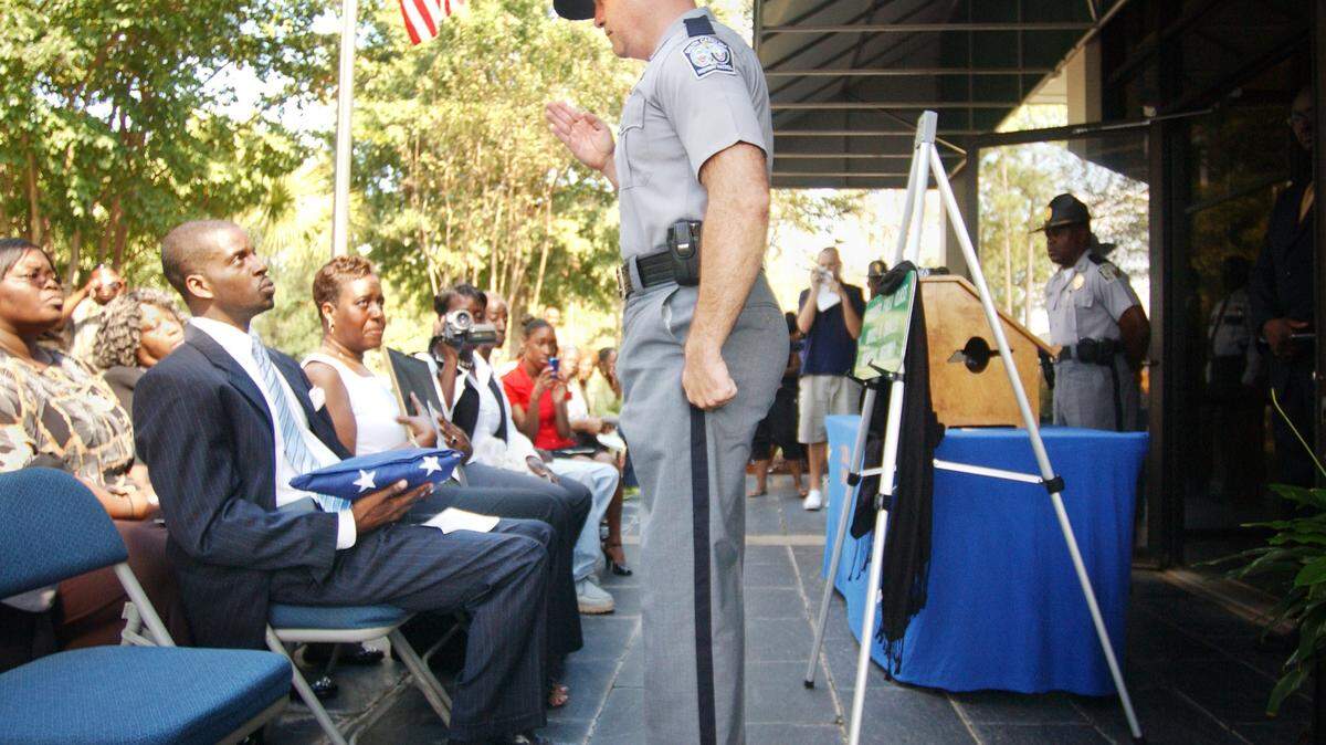 Patrol commander F. Kenny Lancaster Jr. salutes after presenting the American flag to Kevin Smalls during a memorial service honoring Smalls’ father, Bruce K. Smalls, who was shot and killed during a traffic stop in Jasper County on Sept. 27, 1985. During the ceremony at the S.C. Welcome Center on I-95 in Jasper County, a portion of the interstate running through Jasper County was dedicated as the Trooper 1st Class Bruce K. Smalls Memorial Highway.
