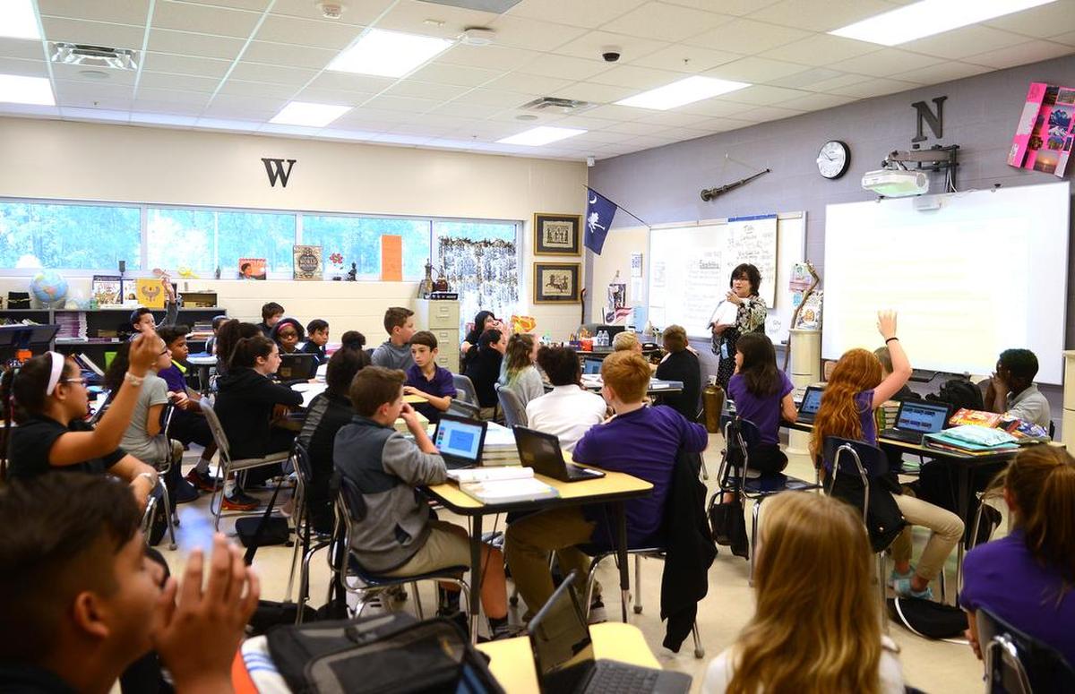 A sixth grade classroom at River Ridge Academy listens to their teacher on Thursday, Oct. 19, 2017 in Bluffton. This class has 42 students in it and is the largest class at River Ridge Academy.