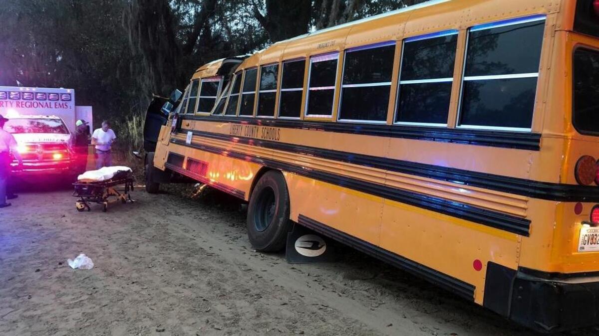 Authorities investigate the scene where a school bus crashed on Tuesday in Gumbranch, Ga.