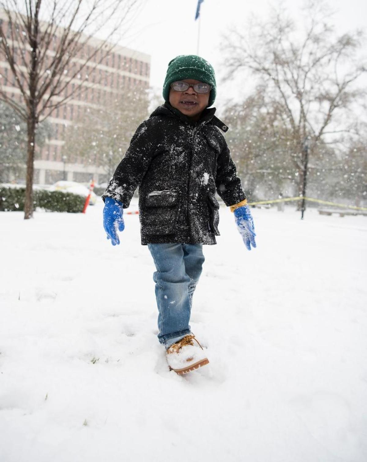 EJ Wright, 3, plays in the snow outside Medical University of South Carolina in Charleston on Wednesday, Jan. 3. EJ has been in the hospital since September waiting for a heart transplant.