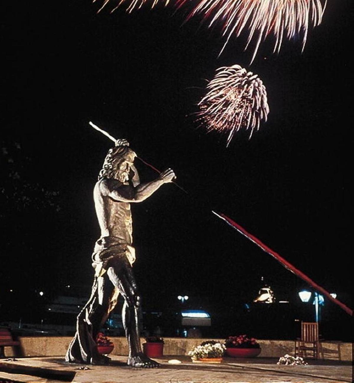 Fireworks explode in the sky in the background behind the statue of Neptune at Shelter Cove on Hilton Head Island in this photo from the 2011 HarbourFest.