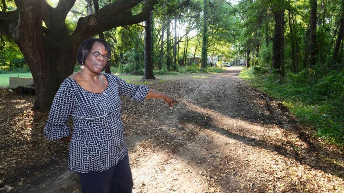 Vanessa Miller points, in April 2015, to ruts along the shoulder of the road she lives on: Benjamin Drive off of Jonesville Road on the north end of Hilton Head Island.
