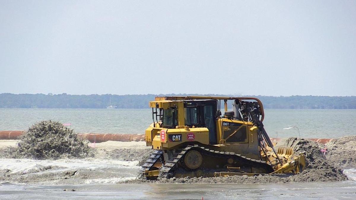 A bulldozer operator with Weeks Marine does beach renourishment work near Islander Beach Park on Hilton Head, Monday, June 27, 2016. Ongoing beach renourishment activities may interrupt couples looking to recite their vows by the sea in 2026.