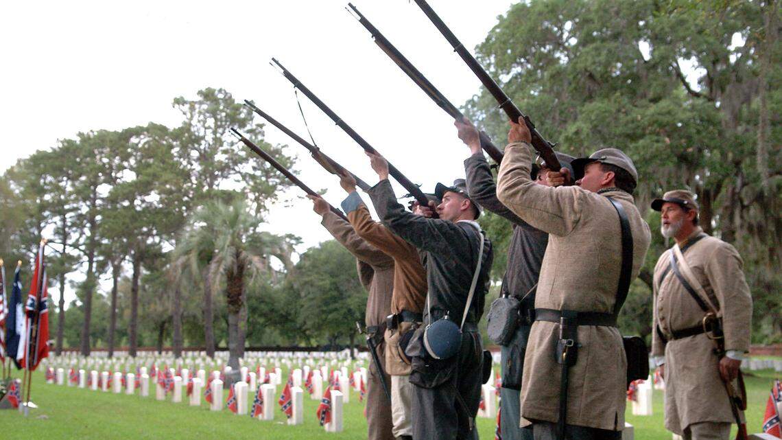 Members of the 11th South Carolina Volunteer Infantry fire their muskets after playing taps at the end of the Confederate Memorial Day service at the Beaufort National Cemetery in 2010.
