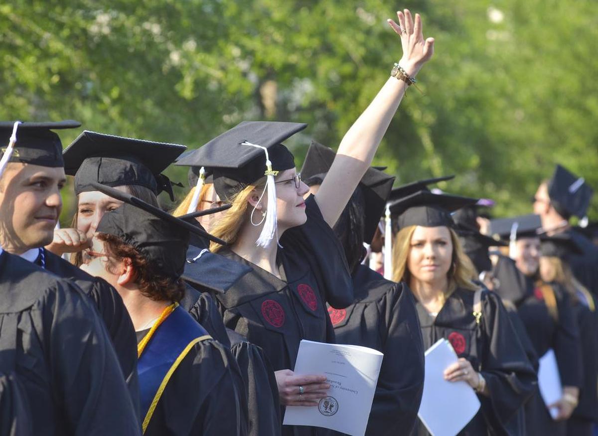 A graduate waves to loved ones in the crowd during the University of South Carolina Beaufort's commencement ceremony on April 28, 2017. The commencement was held on the library plaza of the Hilton Head Gateway campus. The 2017 graduating class of 398 students was the largest in the university's history. Dr. Belle S. Wheelan, the first African American president of the Southern Association of Colleges and Schools Commission, delivered the keynote address