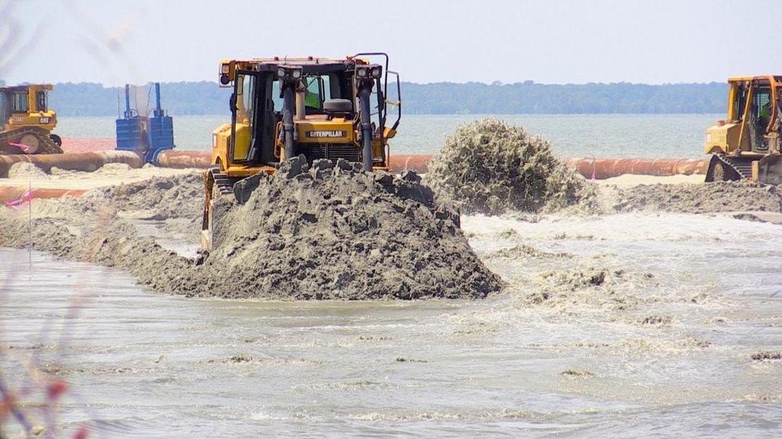 A bulldozer operator with Weeks Marine does beach renourishment work near Islander Beach Park on Hilton Head, Monday, June 27, 2016. The $20 million dollar, island-wide project is set run through October.