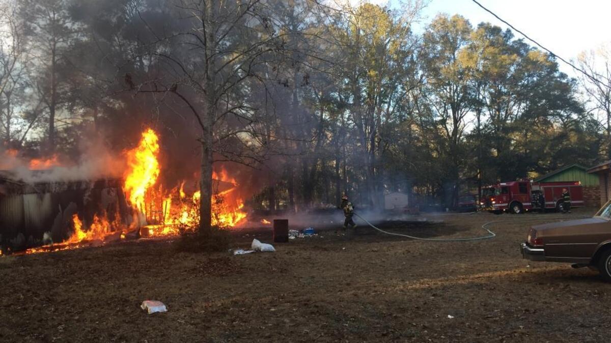 Firefighters battle a blaze that destroyed a mobile home in the Spring Hill area of Ridgeland on Tuesday afternoon.