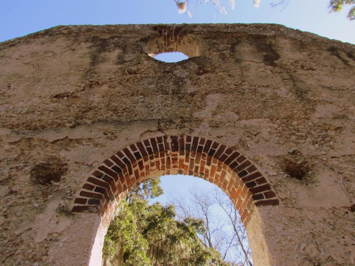 Sanctuary of the islands: St. Helena Chapel of Ease was constructed of tabby and brick in 1740 and lost to forest fire in the century that followed. Its haunting beauty is evident under blue sky and live oaks where it is home to colonial history and ghostly legends.