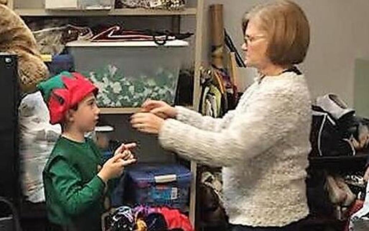 Pat Willcox checks the fit on a cast member of “Elf, Jr.” in the costume department at the University of South Carolina Beaufort.