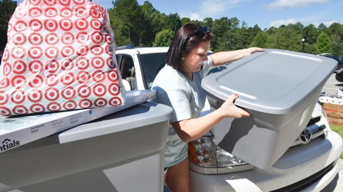 Freshman Sunny McAlhaney, of Hampton, takes containers full of her belongings out of her car as she moves in to her dormitory at USCB’s Hilton Head Gateway Campus during move-in day on Sunday. McAlhaney was one of some 500 freshmen moving in with the help of family, friends, upperclassmen volunteers and USCB staff. The first day of classes is Thursday.