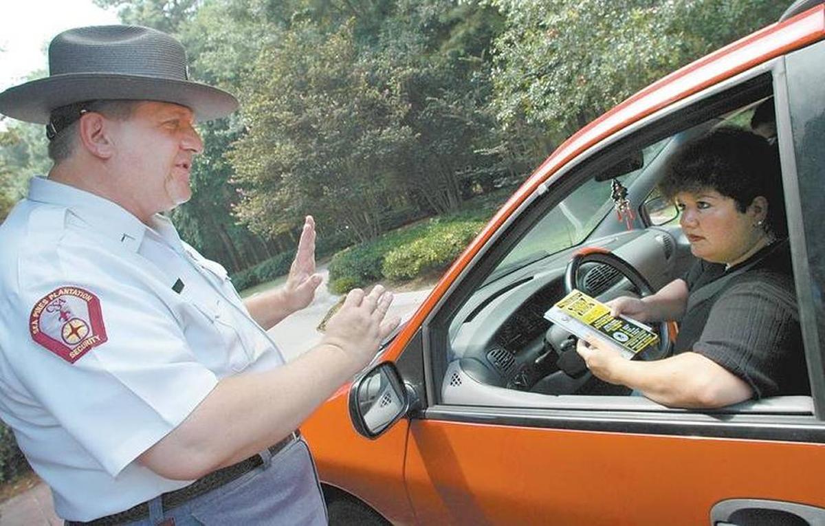 A Sea Pines security officer gives directions to a motorist in this 2017 file photo.