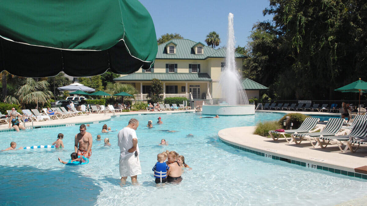 Vacationers enjoy a dip in the pool at Spinnaker Resorts’ Waterside timeshare complex on Hilton Head Island.