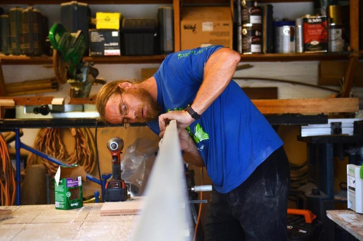 Ben Vaught, aka 'Running Jesus', works on a cabinet for a client on Tuesday afternoon in his garage workshop at his home in Bluffton. Vaught owns and operates Ben Vaught Woodworking.