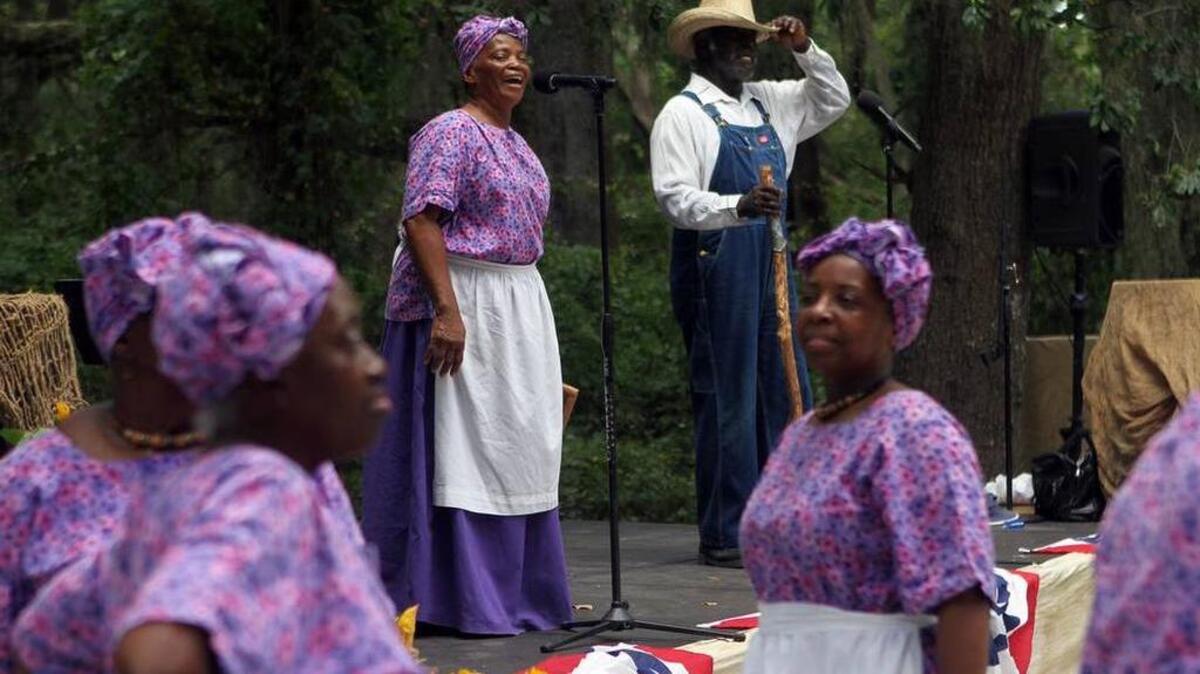 Joann Ross and Jack Evans sing a song on stage while the rest of the Geechee Gullah Ring Shouters dance during the Juneteenth Celebration hosted by the Mitchelville Preservation Project in 2015 at the Fish Haul Park on Hilton Head Island.