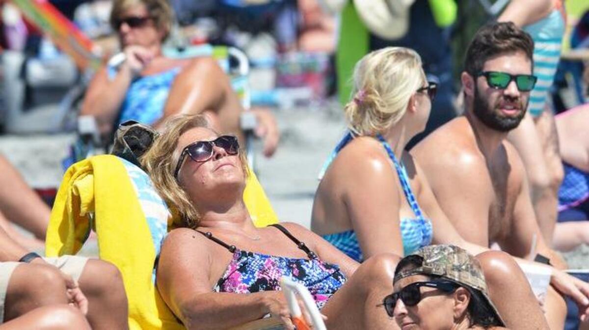 Labor Day beachgoers bask in the late summer sun at Coligny Beach Park on Sept. 5, 2016.