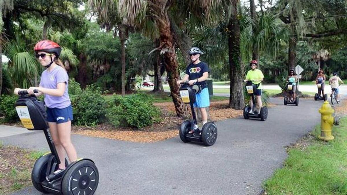 Tourists head down the South Forest Beach Drive leisure trail as they explore Hilton Head Island on a Segway of Hilton Head tour. Staff photo