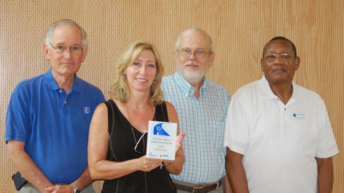 Dataw Island Adopt-A-Highway leaders Bill Carpenter, Melanie Gentile, Neville Patterson, Beaufort County Councilman Bill McBride accept the County Group of the Year Award earlier this month.
