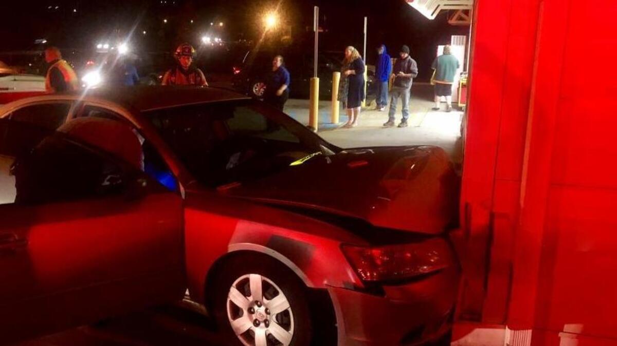 A car rests against a Dollar General on Thursday, one of four vehicle crashes the Burton Fire District responded to that day.