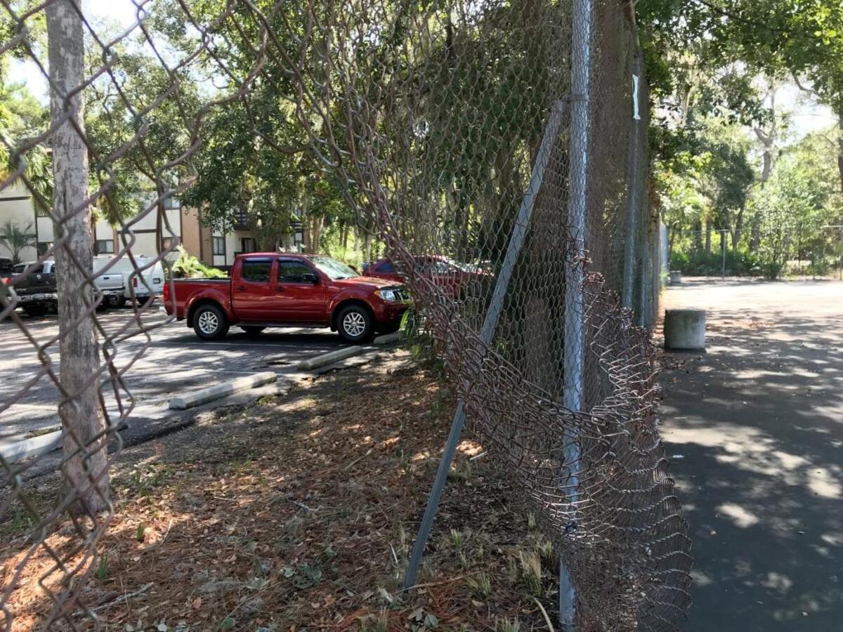 A large tear in the chain-link fence of public tennis courts at Cordillo Courts as seen on Oct. 5, 2017.