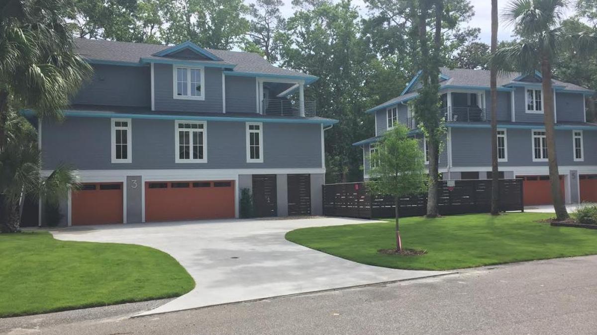 Two Heron Street properties have sparked controversy because of a common deck that opponents contend violates setback and buffer requirements. The town’s land management ordinance official waived the requirements, determining the properties function as a single unit.