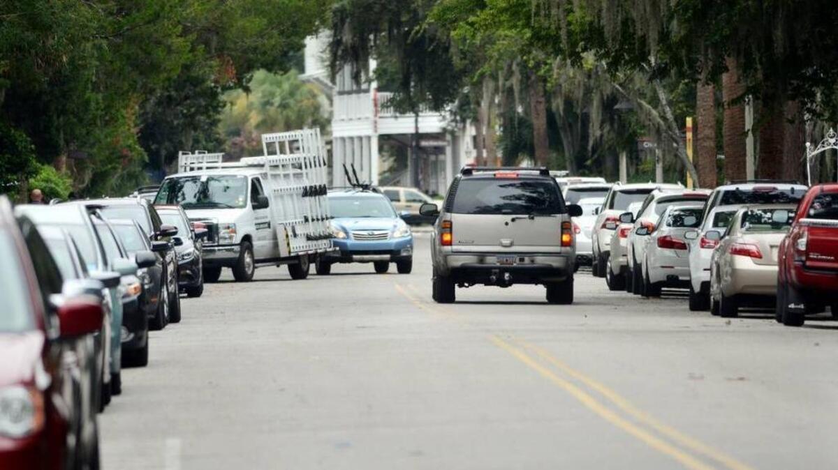 Traffic crawls between rows of parked cars on Calhoun Street in Old Town Bluffton. Town leaders are considering changes to regulations that could require developers to include more parking in future projects.