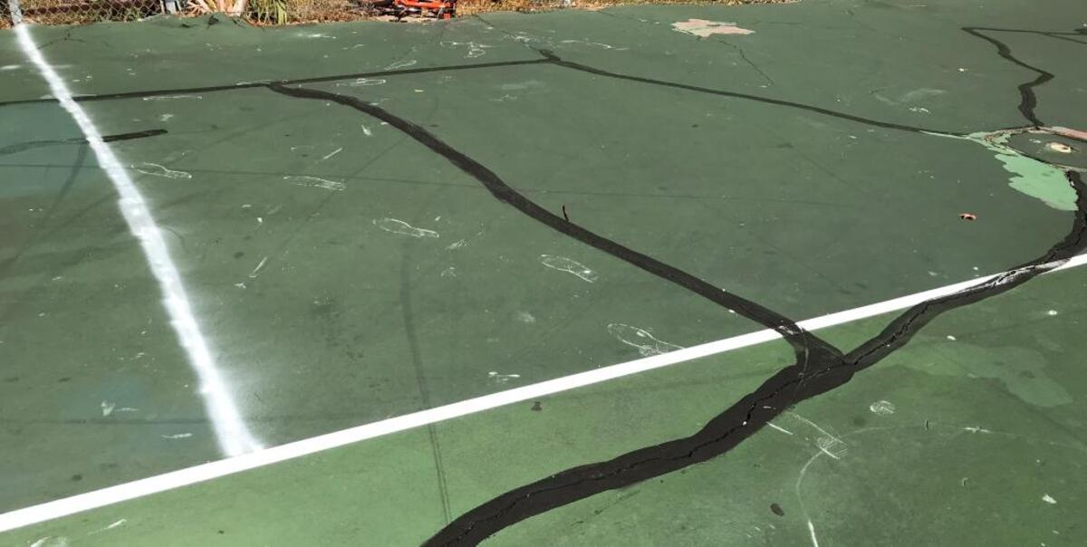 Paint footprints stain part of public owned tennis courts at Cordillo Courts, as seen on Oct. 5, 2017.