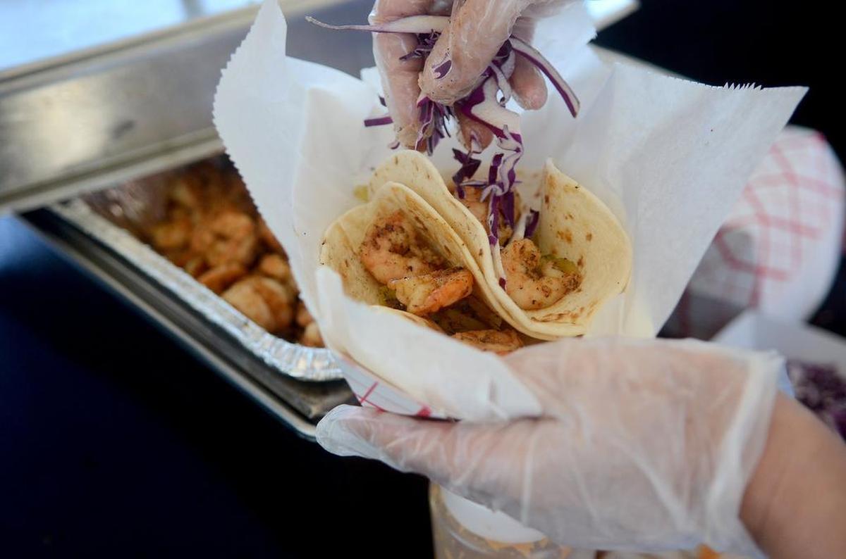An employee of Gilligan’s assembles a shrimp taco for a patron during the Taste of Beaufort on Saturday, May 6, 2017, at Henry C. Chambers Waterfront Park in Beaufort.