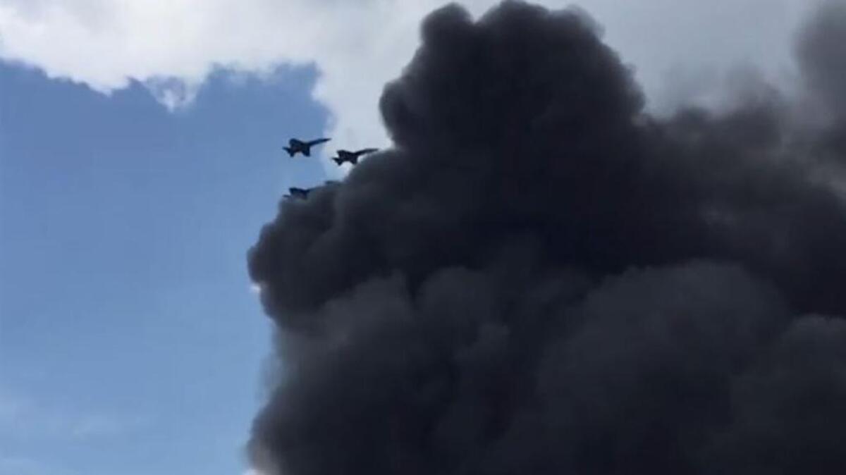 Fellow Blue Angels pilots fly above smoke billowing from the wreck of Marine Capt. Jeff Kuss’ F/A-18 aircraft after it wrecked during a practice run prior to the Smyrna Air Show on June 2, 2016, in Smyrna, Tenn. This image is taken from video recorded by bystanders.