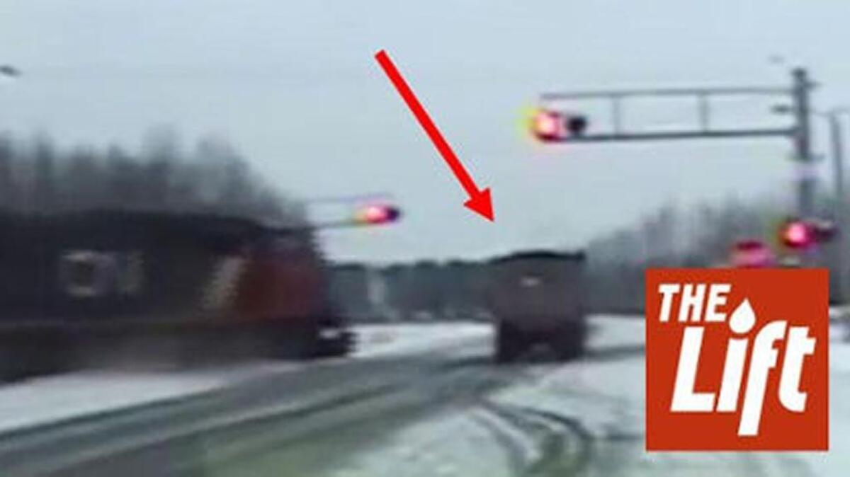 A police car’s dashcam caught video of a tractor trailer pulling in the road, right into the path of an oncoming train.