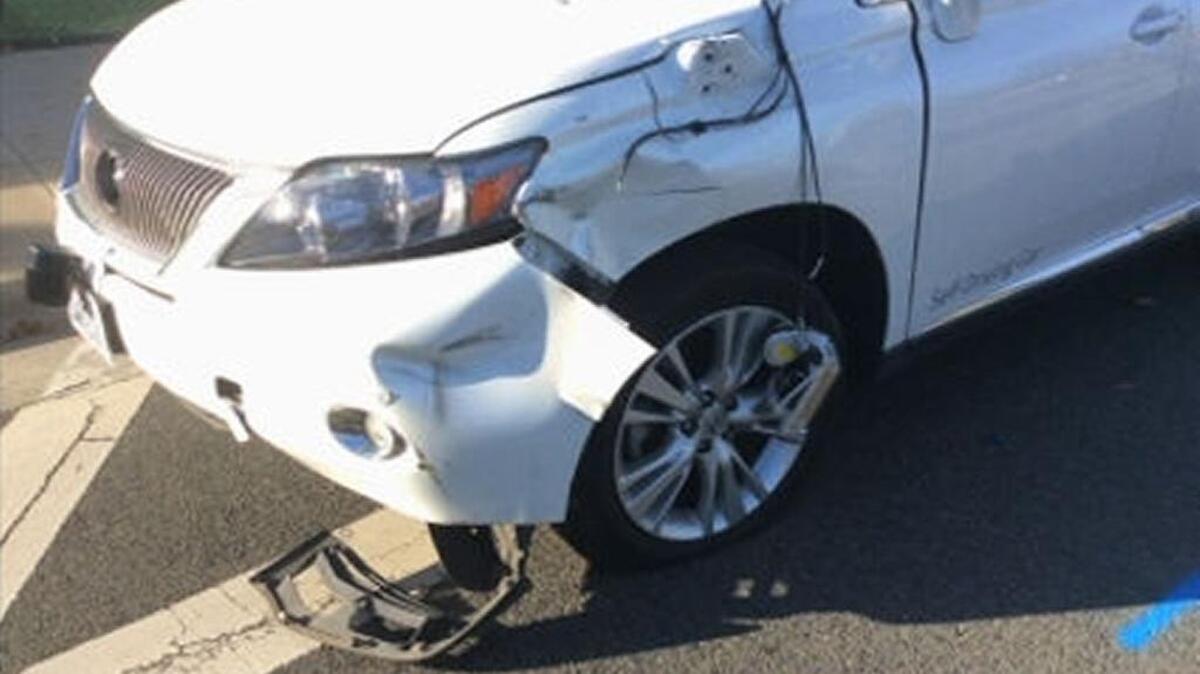 Damage to the front driver’s-side fender can be seen in this Google self-driving Lexus after it collided with a public bus.