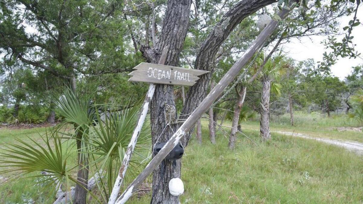 A rustic sign marks one of the trails on Bay Point Island on Sept. 22, 2016.