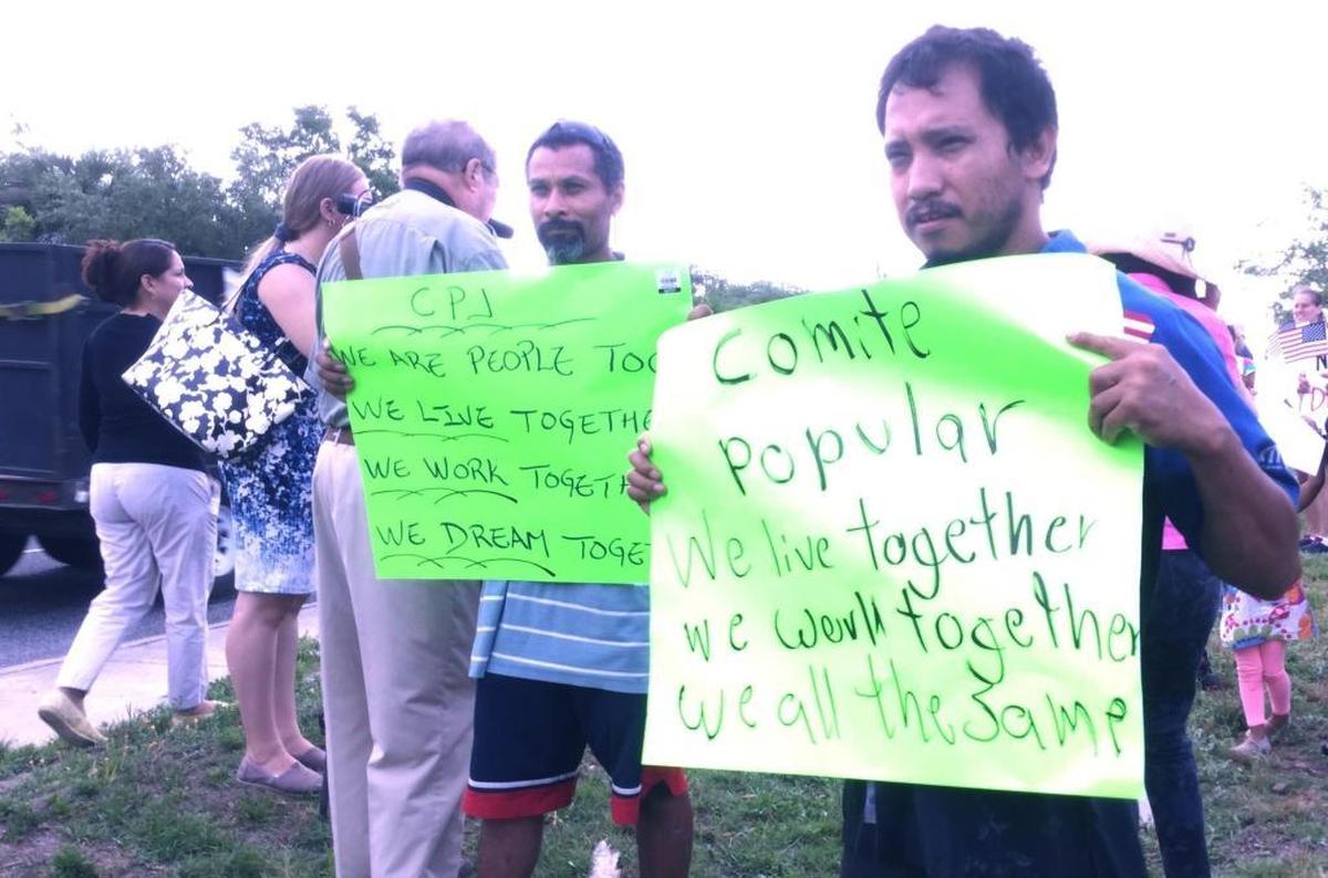 Galdino Larrea, right, and Ernesto Garcia hold signs at a rally in support of area immigrants on Monday, May 1, 2017, on Hilton Head Island. The men are members of Jasper County’s Comité Popular.