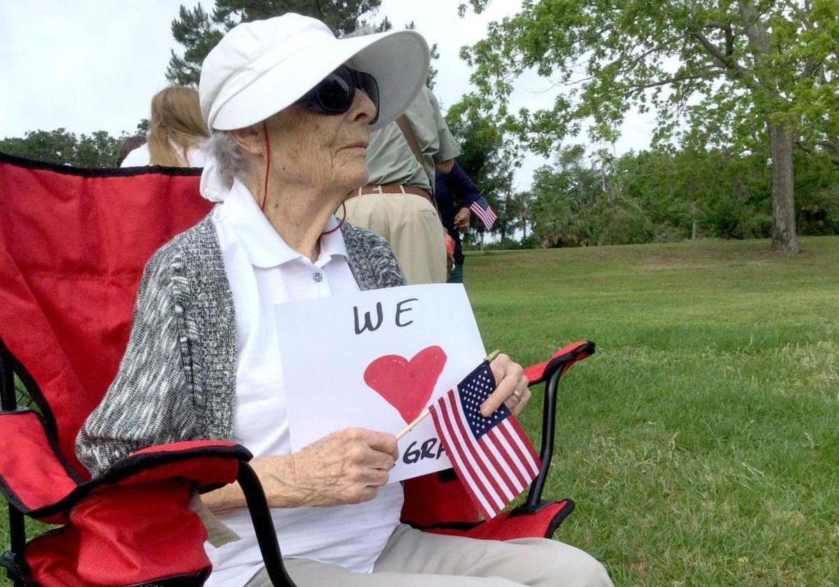 Jean Gross, 98, originally of Chorley, England, holds a sign at a rally in support of area immigrants on Monday, May 1, 2017, on Hilton Head Island. Gross said she immigrated to America on May 1, 1946, after she married an American soldier during World War II.