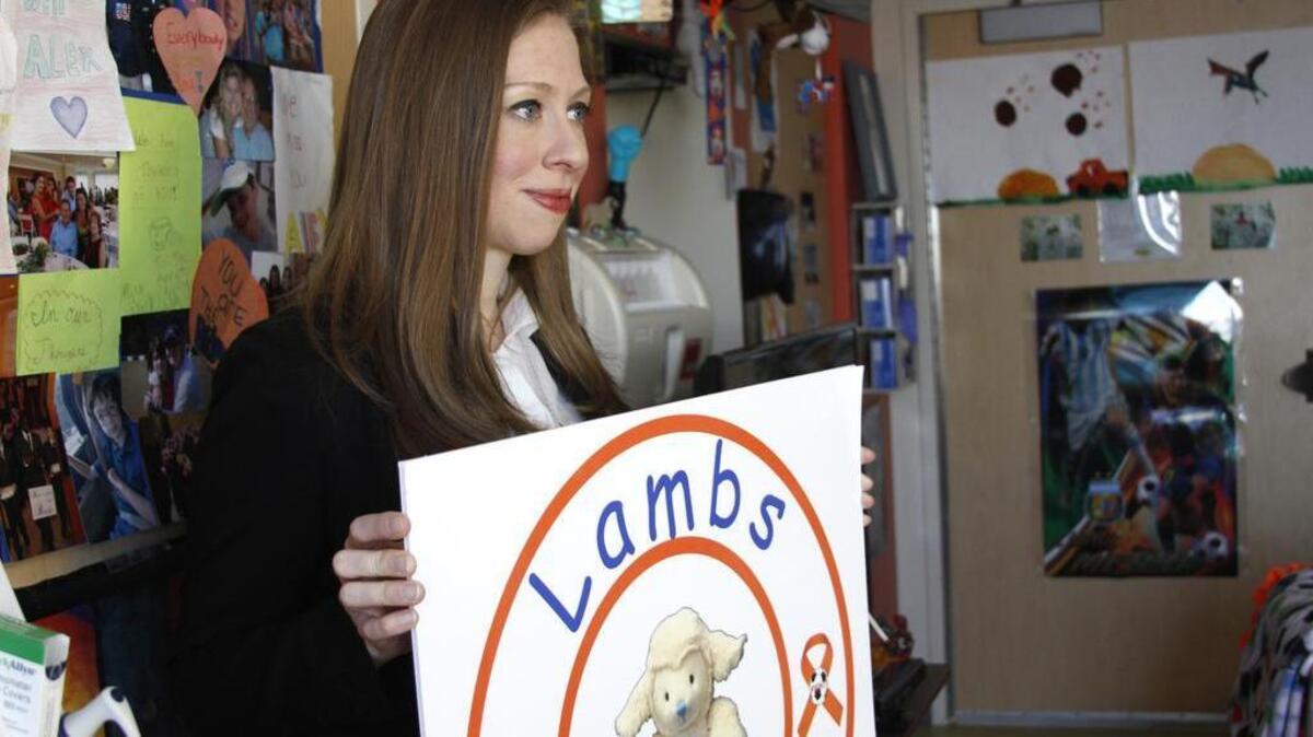 Chelsea Clinton holds a "Lambs for Life" poster Feb. 26 in 10-year-old Hilton Head Island resident Alex Arrieta's hospital room at the Medical University of South Carolina in Charleston. Alex is battling acute myeloid leukemia and came up with the idea of collecting stuffed toy lambs to comfort children who are also battling cancer.