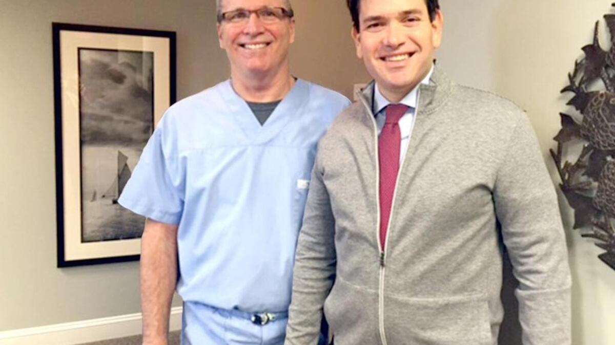 Florida Sen. Marco Rubio, right, has his photo taken with Dr. Dan Hughes of Hughes Dental Group the morning of Feb. 11, 2016, after Rubio needed emergency dental work after breaking a tooth on a frozen candy bar while in town for a campaign rally at Sun City Hilton Head.