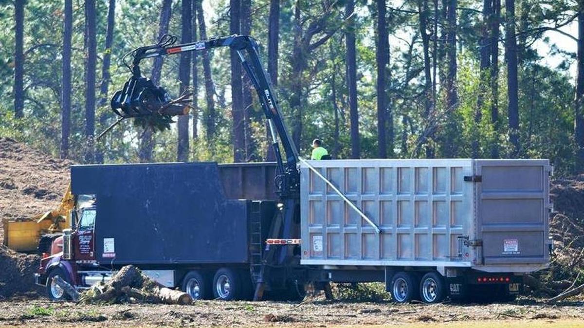 A tandem truck with a built-in crane unloads debris at Hilton Head Island’s Chaplin Park after Hurricane Matthew.