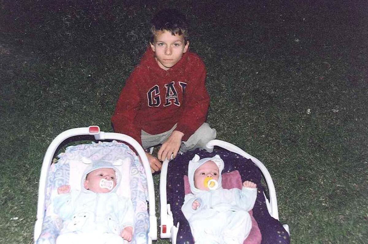 A young Andrey Golubets poses with his younger brothers — twins, now teenagers — in this family photo.