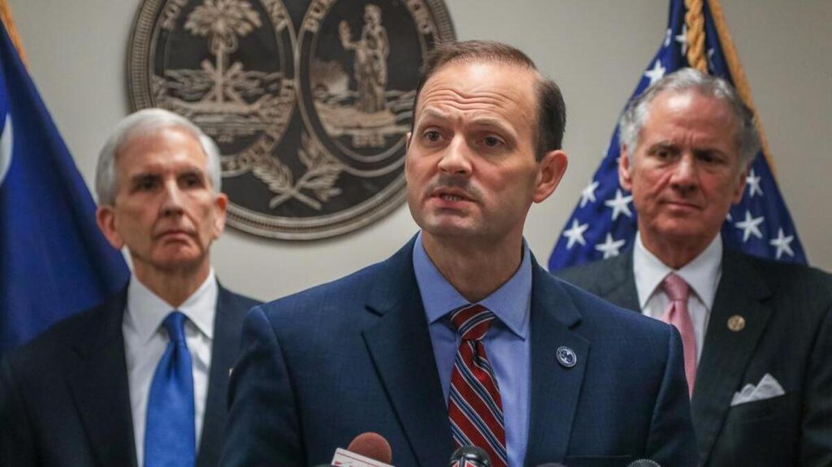 S.C. Attorney General Alan Wilson speaks at a news conference about the firing of special prosecutor, 1st Circuit Solicitor David Pascoe. Behind Wilson are former attorneys general, Charlie Condon (left) and Lt. Gov. Henry McMaster.