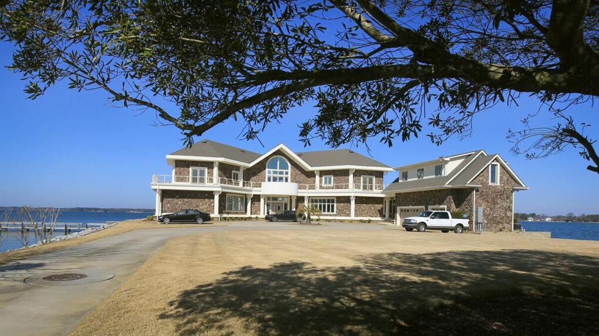 USC head football coach Will Muschamp has purchased this 9,417-square-foot home at Lake Murray. The home has five bedrooms and five full bathrooms. It also includes a 2,644 square foot guest house nestled on the island property. The home is shown here just before the 2013 Lake Murray Association Pontoon Tour of Homes.