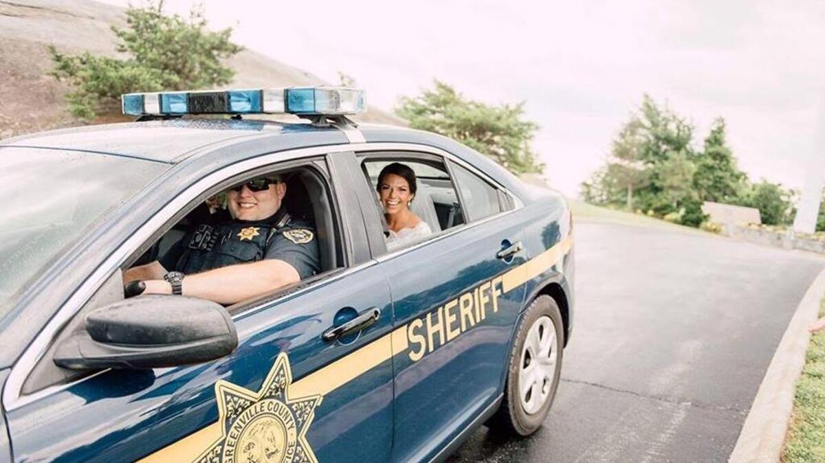 Greenville County Deputy Taylor West drives Kelly Bushey to her wedding ceremony in a squad car after her limo broke down 30 minutes away from the chapel.