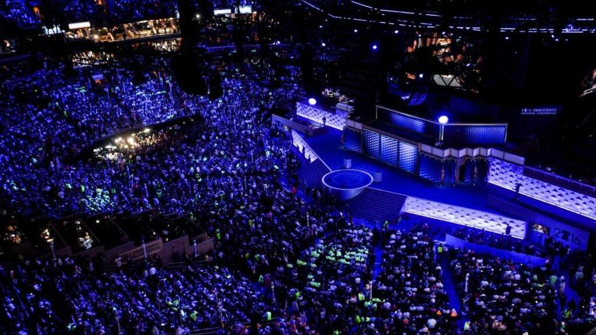 Democrats are bathed in blue light while awaiting speakers on the final night of the Democratic National Convention in Philadelphia.