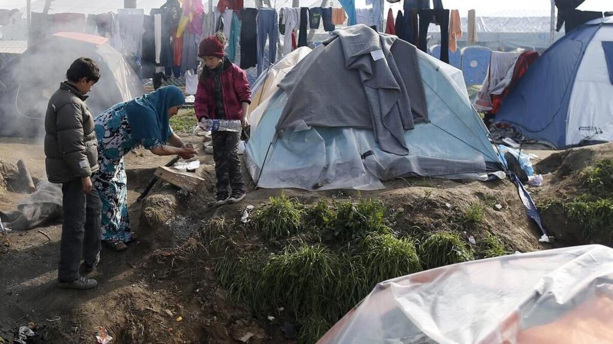 A migrant washes her hands at a makeshift refugee camp at the northern Greek border point of Idomeni, Greece, Monday, March 21, 2016. Hundreds of mostly Syrian asylum-seekers continued to arrive in Greece by sea Sunday despite the start of an international agreement to send migrants back to Turkey.