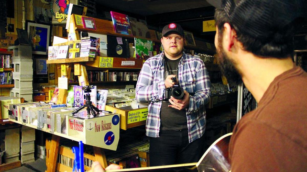 David Stringer films an acoustic performance by Columbia musician Brian Robert at Papa Jazz Record Shoppe. He has been filming “Papa Jazz Sessions” once a week for a year. He plans to film in other locations across South Carolina soon.